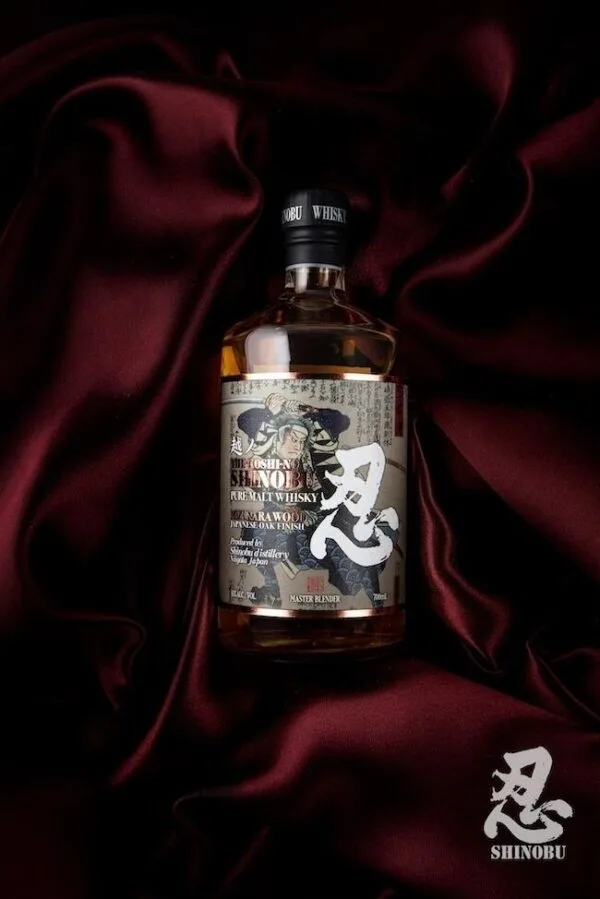 A bottle of the Shinobu Pure Malt whisky on red velvet