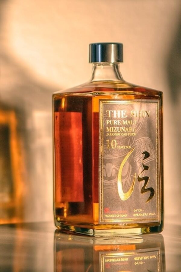 a bottle of the Shin pure malt 10 year old Japanese Whisky with a shadow behind