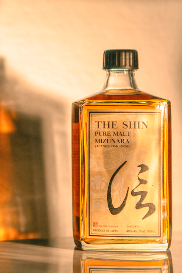 a bottle of the Shin pure malt with a shadow behind