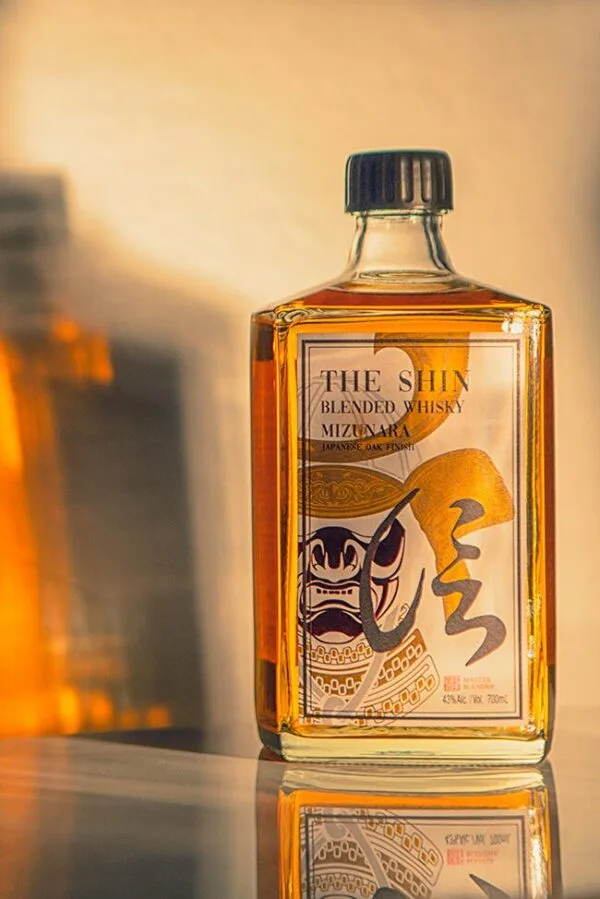 A bottle of the Shin blended whisky with a shadow behind
