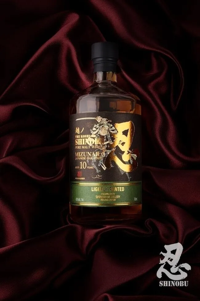 A bottle of the Shinobu lightly peated Pure Malt 10 year old whisky on red velvet