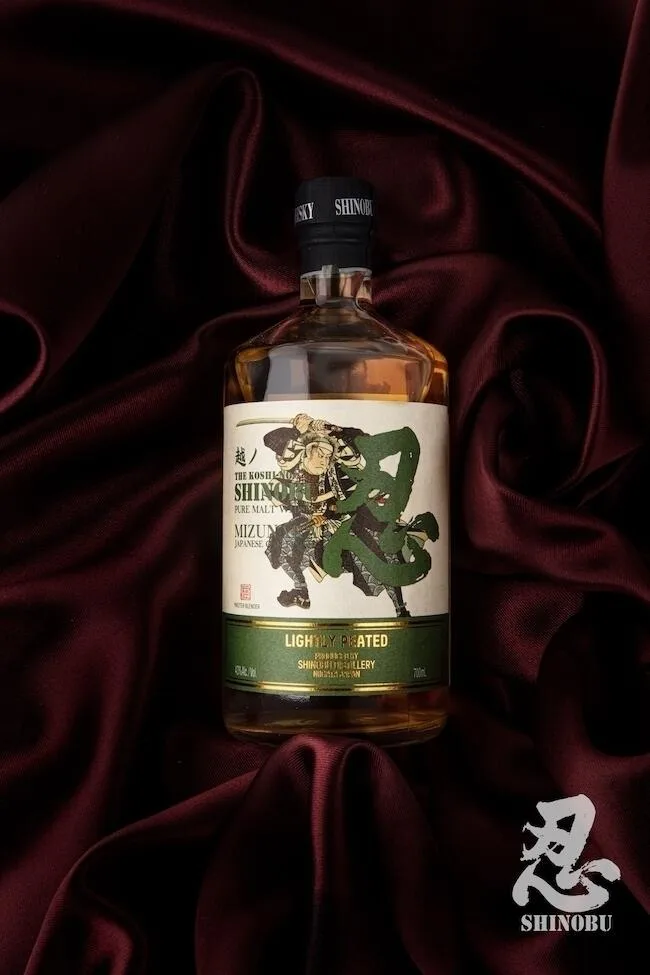A bottle of the Shinobu lightly peated Pure Malt whisky on red velvet