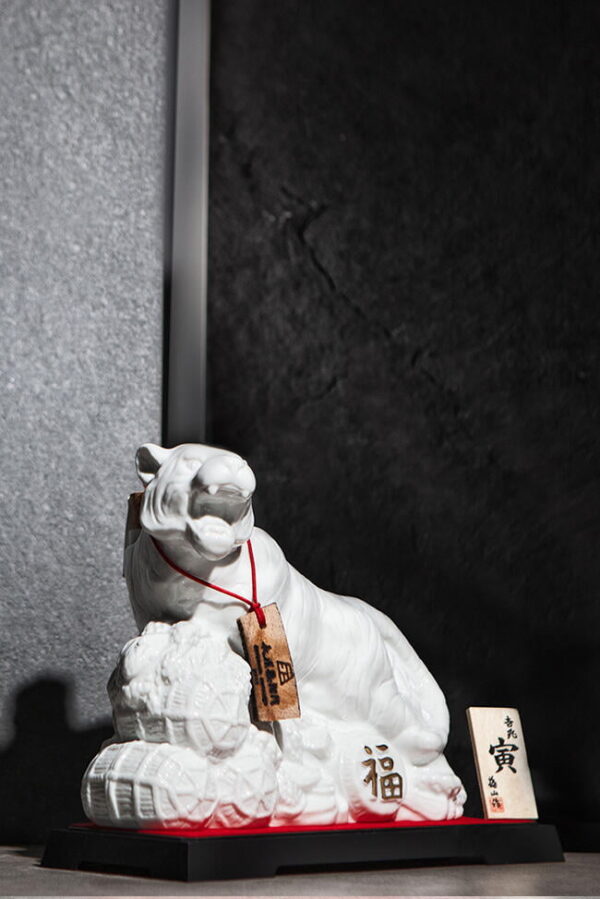 a bottle of a white tiger against a wall in a moody shot