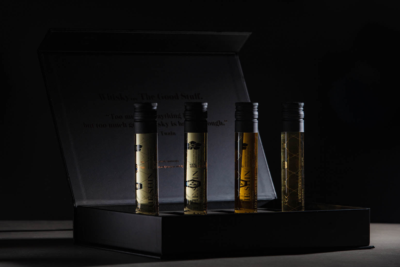 An image of the Japanese Whisky tasting experience box open showing the 4 vials of whisky standing up